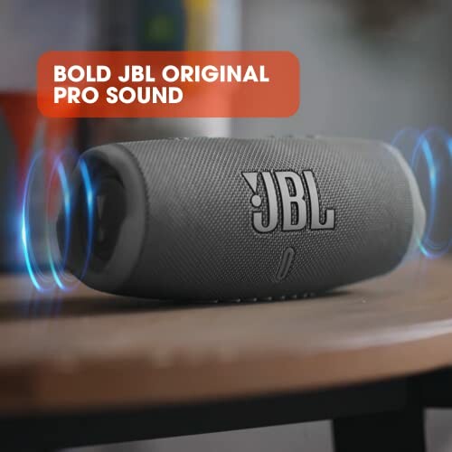 JBL speaker on a table with sound waves